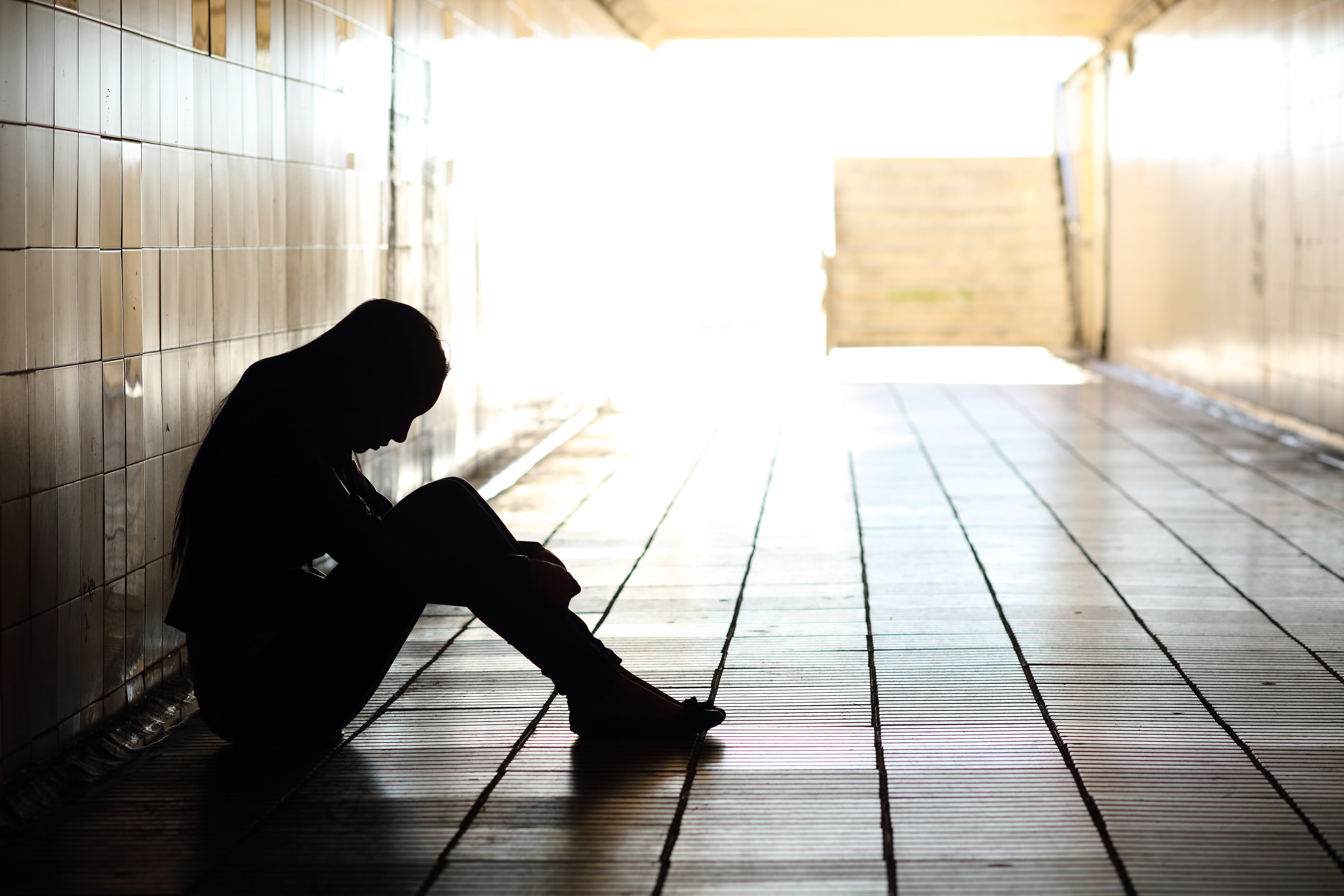 Sad person sitting on the ground