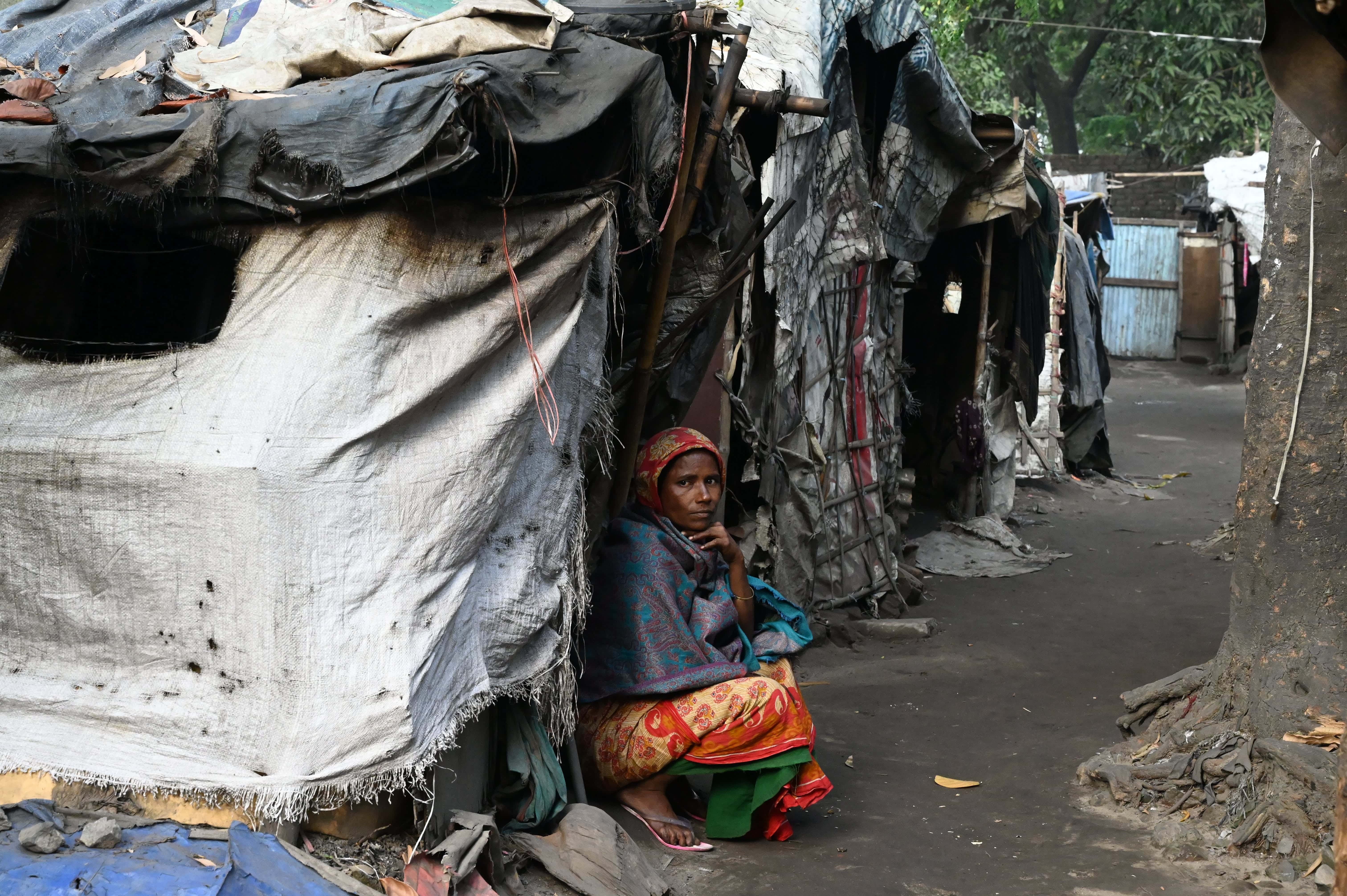 Women sitting outside of a small shack